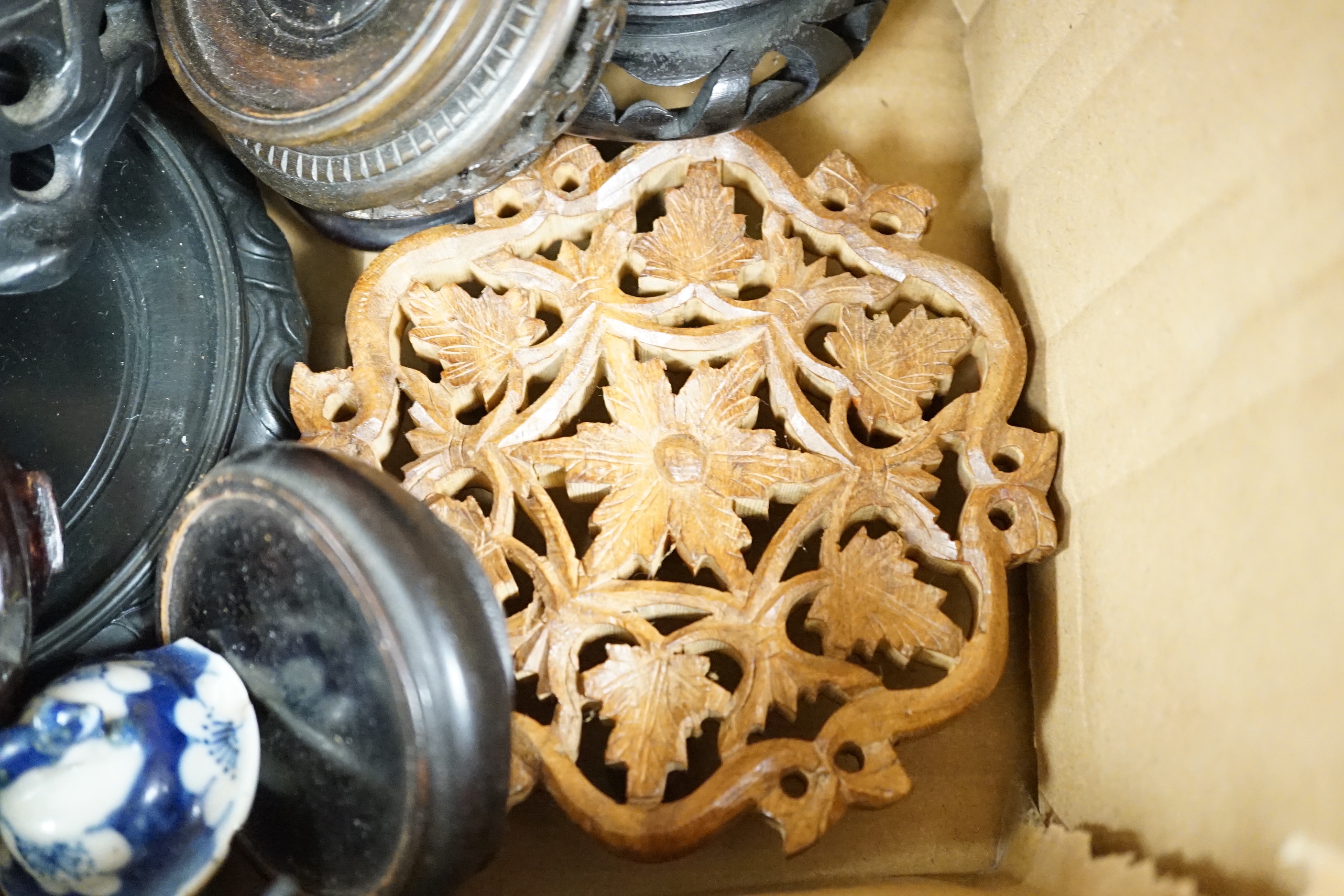 A group of Chinese wooden stands and ceramic lids